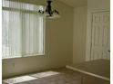 Dining area with a chandelier, a large window, and neutral-colored walls at 11206 W Granada Rd, Avondale, AZ 85392