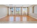 Well-lit Living Room with hardwood floors, light colored walls, and three large windows at 11405 E Rafael Ave, Mesa, AZ 85212