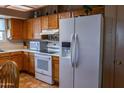 Well-lit kitchen showcasing wooden cabinets and modern white appliances, creating a welcoming culinary environment at 1213 N Raven --, Mesa, AZ 85207