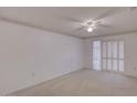 Bright bedroom featuring a ceiling fan and sliding glass doors at 12887 N 99Th Dr, Sun City, AZ 85351