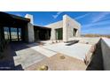 Contemporary home featuring unique desert landscaping, stone accents, and a welcoming entrance at 13116 E Desert Holly Dr, Scottsdale, AZ 85255