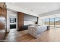 Contemporary kitchen featuring an island with marble countertop and sleek custom cabinets at 13116 E Desert Holly Dr, Scottsdale, AZ 85255