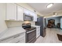 Well-lit kitchen with sleek countertops, stainless steel appliances and bright white cabinets at 13251 W Aleppo Dr, Sun City West, AZ 85375