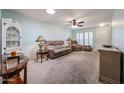 Comfortable living room with plush seating, ceiling fan and natural light from bright windows at 13251 W Aleppo Dr, Sun City West, AZ 85375