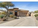 Inviting single-story home with manicured desert landscaping, a tile roof, and a spacious driveway at 14442 N Prickly Pear Ct, Fountain Hills, AZ 85268