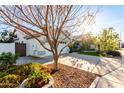 View of a well-maintained home featuring a spacious driveway, desert landscaping, and a two-car garage at 1573 W Chicago St, Chandler, AZ 85224