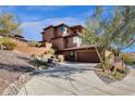 Exterior view of the home showcasing the driveway and lush desert landscaping at 16210 E Links Dr, Fountain Hills, AZ 85268