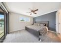 Bright main bedroom boasts a ceiling fan, neutral carpet, and access to the outdoor patio at 1709 W Clarendon Ave, Phoenix, AZ 85015