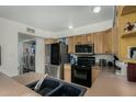 Functional kitchen featuring stainless steel appliances, wood cabinetry, and a practical layout at 1717 E Union Hills Dr # 1065, Phoenix, AZ 85024