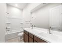 Bright bathroom featuring double sink vanity with a bathtub and shower combination at 18166 E Colt Dr, Queen Creek, AZ 85142