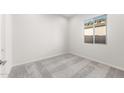 Comfortable bedroom with gray carpeting and a window offering natural light at 18166 E Colt Dr, Queen Creek, AZ 85142