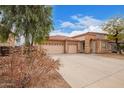 Attractive single-story home with three-car garage and low maintenance desert landscaping at 18415 W Port Au Prince Ln, Surprise, AZ 85388