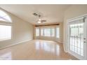 Bright living room with high ceilings, ceiling fan, and a multitude of windows that let in natural light at 19507 N 90Th Ln, Peoria, AZ 85382