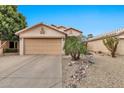 Charming single-story home with a two-car garage, low-maintenance landscaping, and a desert rock garden at 22412 N 20Th Pl, Phoenix, AZ 85024