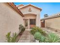 Inviting front entrance with desert landscaping, a tiled walkway, and a cozy bench at 22412 N 20Th Pl, Phoenix, AZ 85024