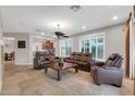 Spacious living room with a ceiling fan and comfortable brown leather furniture at 2404 W Muirfield Dr, Anthem, AZ 85086