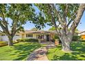 Beautiful home with lush green lawn, mature trees, and a brick pathway leading to the entrance at 4826 N 34Th Pl, Phoenix, AZ 85018