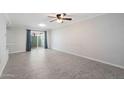 Bright and airy living room showcases tile flooring and sliding glass door to an outdoor patio area at 5106 N 17Th Ave # 11, Phoenix, AZ 85015