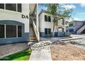 Exterior view of a two-story condo with stairwell access and manicured landscaping at 600 W Grove Pkwy # 2188, Tempe, AZ 85283