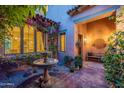 Relaxing courtyard with a stone fountain, colorful bougainvillea, and comfortable seating at 7442 E Golden Eagle Cir, Gold Canyon, AZ 85118