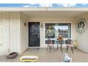 Cozy front porch with seating area, decorative accents, and a welcoming entrance to the home at 9501 W Hidden Valley Cir, Sun City, AZ 85351