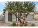 Single-story home with desert landscaping, a covered porch, and a convenient two-car garage at 9509 W Illini St, Tolleson, AZ 85353