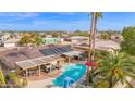 Backyard view showcasing a refreshing pool, covered patio, and vibrant desert landscaping at 9517 W Cedar Hill Cir # N, Sun City, AZ 85351