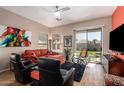 Cozy living room with modern ceiling fan, comfortable seating, and sliding door to backyard at 9617 E Holiday Way, Sun Lakes, AZ 85248