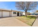 Charming single-story home features a neat front yard, driveway, and a single-car garage at 10324 N 97Th Dr # B, Peoria, AZ 85345