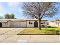 Charming single-story home features a neat front yard, driveway, and a single-car garage at 10324 N 97Th Dr # B, Peoria, AZ 85345