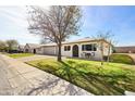 Charming single-story home features a neat front yard, driveway, and a single-car garage at 10324 N 97Th Dr # B, Peoria, AZ 85345