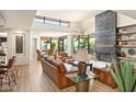 Spacious living room with a fireplace and lots of natural light at 10687 E Fernwood Ln, Scottsdale, AZ 85262