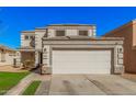 Inviting two-story home features a spacious driveway, manicured lawn, and a charming facade with a two car garage at 12818 W Pershing St, El Mirage, AZ 85335