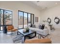 Bright living room with modern decor, comfortable seating, and sliding glass doors to the outdoor space at 14445 N Valencia Dr, Fountain Hills, AZ 85268