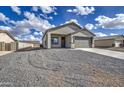 Charming single-story home featuring a two-car garage and low-maintenance gravel landscaping at 14951 S Capistrano Rd, Arizona City, AZ 85123