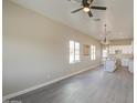 Bright, open-concept living room features modern ceiling fan and hardwood floors at 14951 S Capistrano Rd, Arizona City, AZ 85123