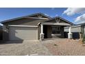 Charming single-story home featuring a two-car garage and desert landscaping at 15760 W Beryl Ave, Waddell, AZ 85355