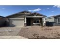 Charming single-story home featuring a two-car garage and desert landscaping at 15760 W Beryl Ave, Waddell, AZ 85355