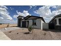 A well-maintained single-Gathering home with desert landscaping and a side view of the property at 15765 W Cheryl Dr, Waddell, AZ 85355