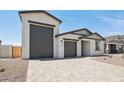 Beautiful home with a three-car garage and neutral-toned exterior paint at 15765 W Cheryl Dr, Waddell, AZ 85355