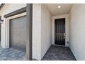 View of home entrance featuring a dark front door and access to the garage at 15765 W Cheryl Dr, Waddell, AZ 85355