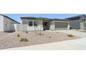 Well-maintained one-story home with a desert landscape, paver driveway, and a two-car garage at 15778 W Cheryl Dr, Waddell, AZ 85355
