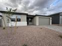 Inviting single-story home with low-maintenance landscaping and neutral exterior paint at 15778 W Cheryl Dr, Waddell, AZ 85355