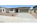 Street view of a cozy single-Gathering home with desert landscaping and a spacious two-car garage at 15778 W Cheryl Dr, Waddell, AZ 85355