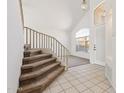 Bright entryway featuring high ceilings, tile floors, carpeted staircase, and a large window at 15825 S 1St Ave, Phoenix, AZ 85045