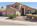 Two-story home featuring a tile roof, desert landscaping, and a manicured front yard at 15825 S 1St Ave, Phoenix, AZ 85045