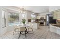 Bright eat-in kitchen with granite counters, island, stainless appliances, and backyard pool views at 15825 S 1St Ave, Phoenix, AZ 85045