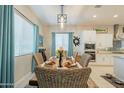 Cozy dining area with large windows, chandelier and a decorative rug at 15843 S 177Th Ave, Goodyear, AZ 85338