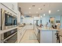 Modern kitchen featuring white cabinets, stainless steel appliances, and granite countertops at 15843 S 177Th Ave, Goodyear, AZ 85338