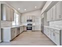 Bright kitchen boasts gray cabinets, stainless appliances, and ample counter space at 19824 N 94Th Ln, Peoria, AZ 85382